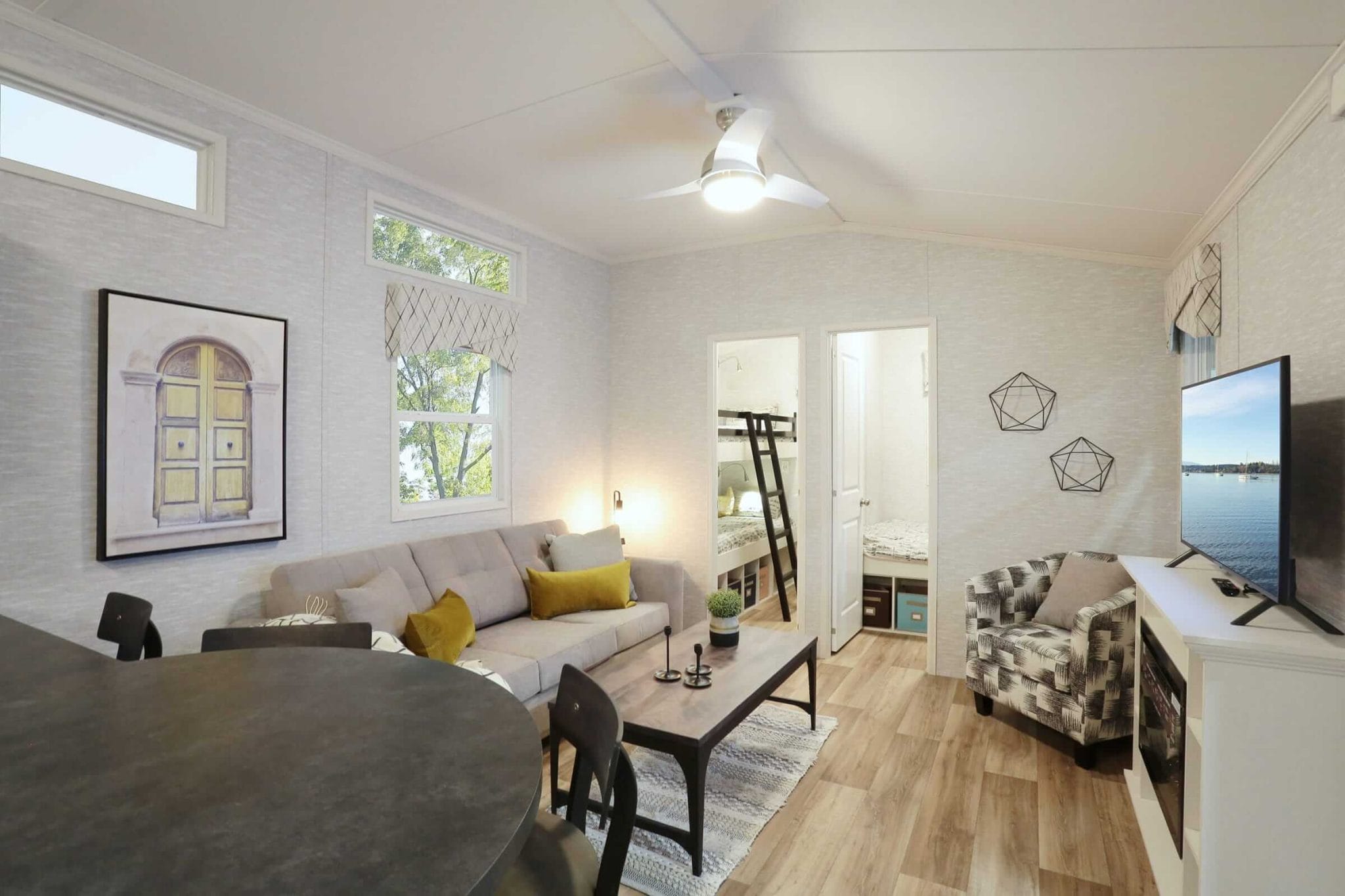 Cozy living room featuring a couch, table, and television, showcasing the Frontier Series design.