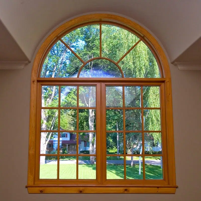 Custom Windows & Doors featuring a window with a scenic view of a lush park outside.