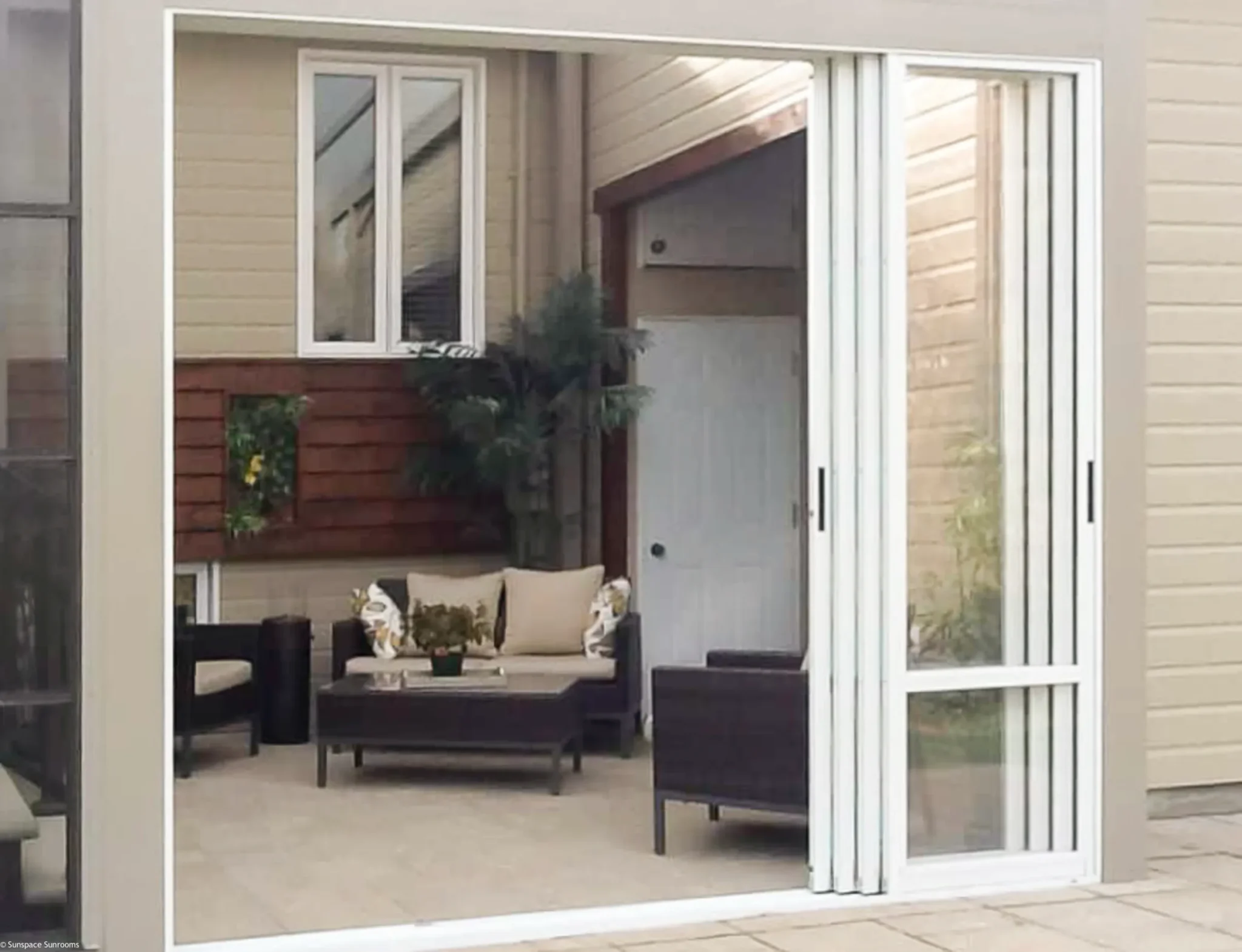 WeatherMaster™ Windows image of a patio featuring a sliding glass door and stylish patio furniture.