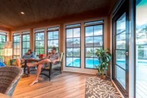 A couple enjoys their time in a Sunroom, highlighting the features of WeatherMaster™ Windows in a warm atmosphere.
